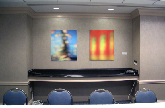 2 abstract photographs hanging on wall of meeting space
