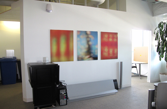 3 abstract photographs hanging on wall of an office