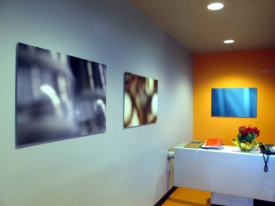 3 abstract photographs hanging on wall of office space