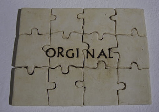 ceramic puzzle complete with the word ORGINAL