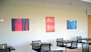 3 abstract photographs hanging on wall of meeting space