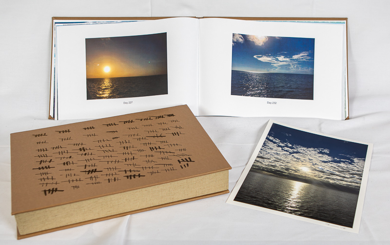 Sand Colored Leather bound Artist book with burned hash marks, photographs of the ocean