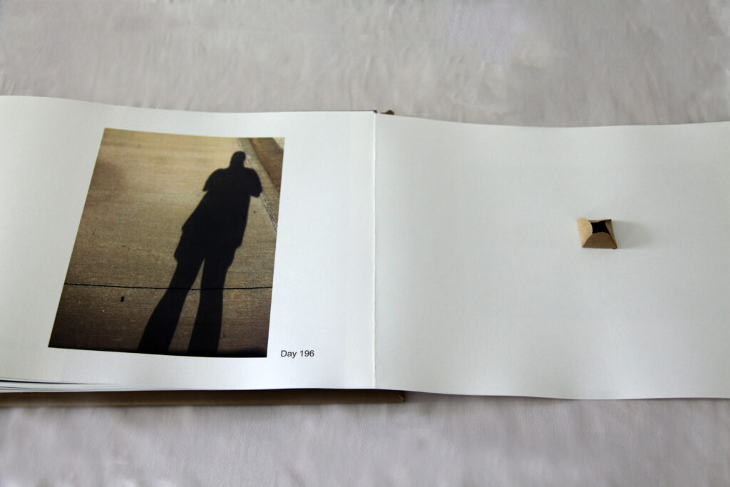 Left page is photo of artist shadow and right Page close up of envelope slightly open