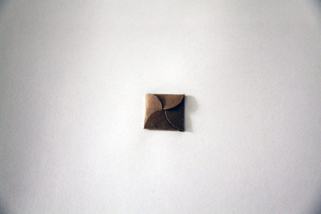 Close up of origami brown penny envelope